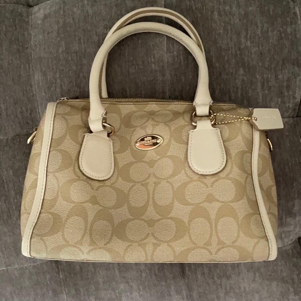 White/tan Coach pocketbook.
